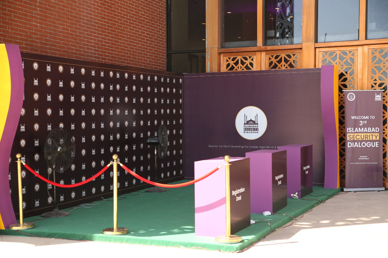 Step-and-repeat backdrop and registration desks branded for the Islamabad Security Dialogue